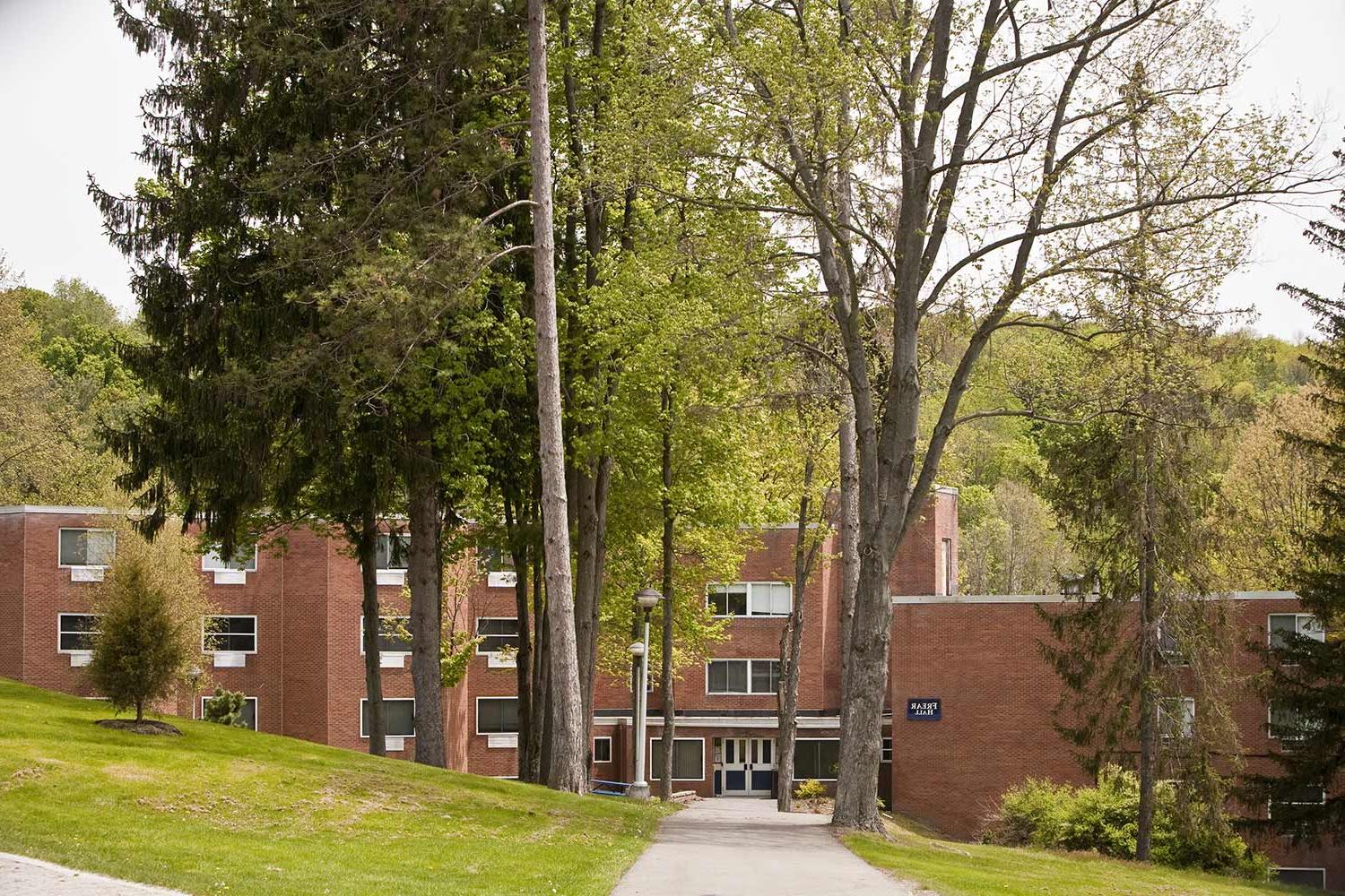 Large brick residence building surrounded by trees at Keystone College.